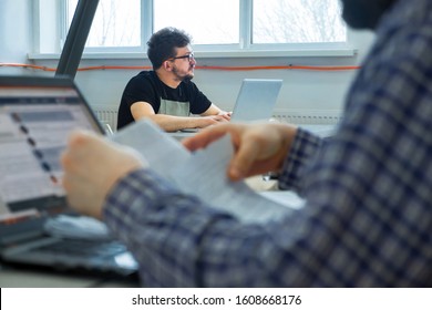 Young Office Worker Looking Outside, Unable To Concentrate On Work, Needing Rest, Boredom, Need Additional Motivation Young Office Worker Ponders Over Work Task In His Workplace