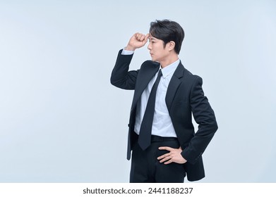 A young office worker man in a navy suit is posing with various facial expressions. - Powered by Shutterstock