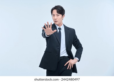 A young office worker man in a navy suit is posing with various facial expressions. - Powered by Shutterstock