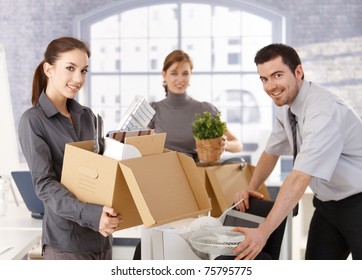 Young Office Workers Moving Office, Unpacking Boxes, Smiling.?