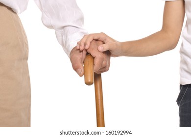 Young and old hands on cane together closeup against white background