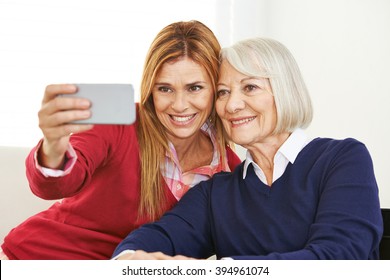 Young And Old Woman Taking Selfie Together With A Smartphone