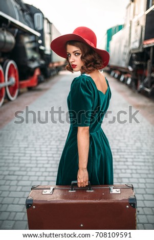 Young old-fashioned woman travels on retro train