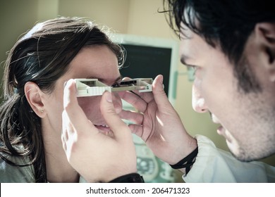 A Young Ophthalmologist Using An Exophthalmometer, An Instrument Used For Measuring The Degree Of Forward Displacement Of The Eye In Exophthalmos