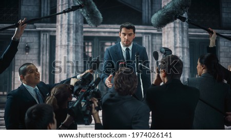 Young Organization Representative Answering Press Questions and Giving Interview Outside a Parliament, Court or Other Government Building. Press Officer or Businessman Crowded by News Journalists.