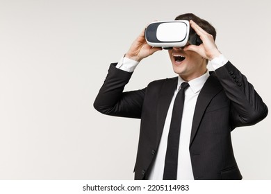 Young overjoyed rich employee business corporate lawyer man 20s in classic formal black grey suit shirt tie work in office watching in vr headset pc gadget isolated on white background studio portrait - Powered by Shutterstock