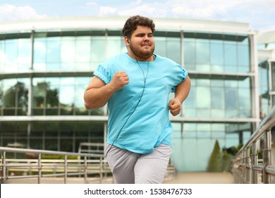 Young Overweight Man Running Outdoors. Fitness Lifestyle