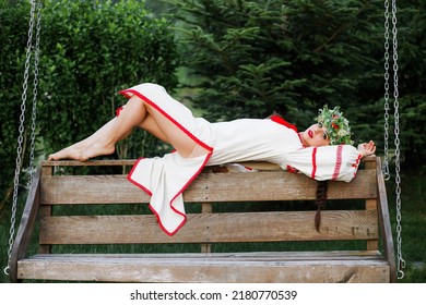 A Young Pagan Girl Lies On A Swing. Celebration Of Summer Kupala