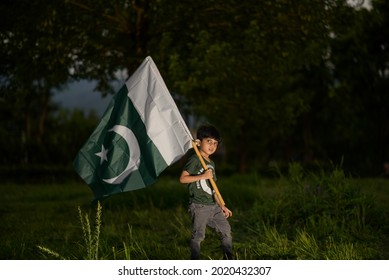 A Young Pakistan Boy Waving A Pakistan Flag, F-9 Park, Islamabad. Pakistan.