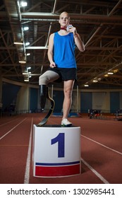 Young Paralympic Champion With Medal Standing On Tribune In Front Of Camera After Games