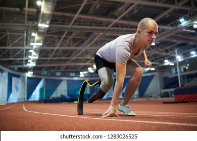 Young Paralympic Competitor Of Marathon Leaning By Start Line On Race Track Before Running