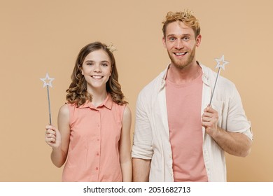 Young parent man with child teen girl wear casual clothes Daddy kid daughter hold princess magic wand feia stick celebrating isolated on beige background studio. Father's Day birthday family concept - Powered by Shutterstock