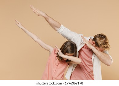 Young Parent Man Have Fun With Child Teen Girl In Casual Pastel Clothes Daddy Little Kid Daughter Do Dab Hip Hop Dance Hands Move Gesture Isolated On Beige Background. Father's Day Love Family Concept