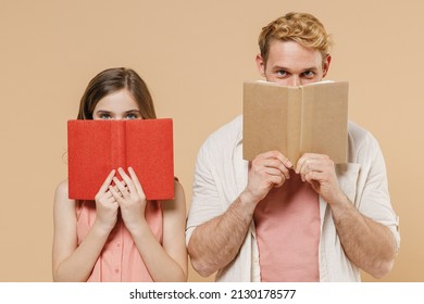 Young Parent Man Have Fun With Child Teen Girl In Casual Pastel Clothes Daddy Little Kid Daughter Reading Hiding Cover Mouth With Book Isolated On Beige Background. Father's Day Love Family Concept