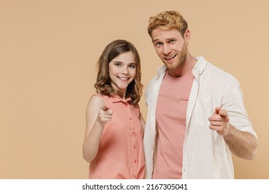 Young parent man have fun with child teen girl in casual clothes. Daddy little kid daughter point index finger camera on you motivate isolated on beige background. Father's Day Love family concept. - Shutterstock ID 2167305041