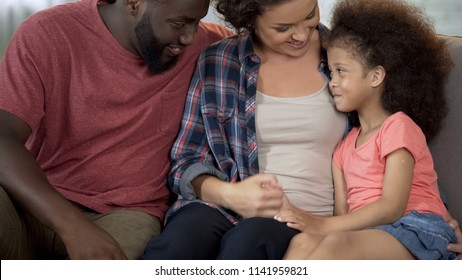 Young parents find approach to shy adopted child, loving and caring family