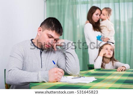 Young parents having quarrel adout documents in front of children in interior Stock photo © 