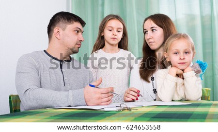 Young parents having quarrel adout documents in front of children indoor Stock photo © 