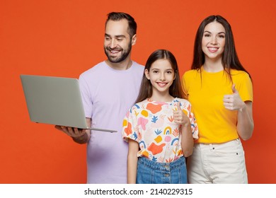 Young Parents Mom Dad With Child Kid Daughter Teen Girl In Basic T-shirts Hold Use Work On Laptop Pc Computer Show Thumb Up Isolated On Yellow Background Studio Family Day Parenthood Childhood Concept