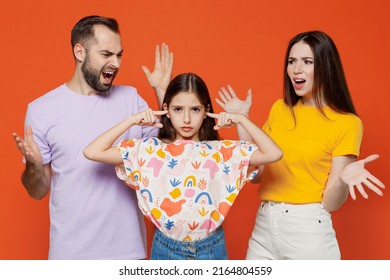 Young parents mom dad with child kid daughter teen girl in basic t-shirts cover ears with hands fingers do not want to listen scream isolated on yellow background studio Family day parenthood concept. - Powered by Shutterstock