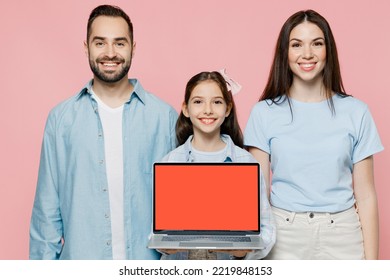 Young Parents Mom Dad With Child Kid Daughter Teen Girl In Blue Clothes Hold Use Work On Laptop Pc Computer Blank Screen Workspace Area Isolated On Plain Pastel Pink Background. Family Day Concept.