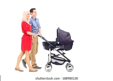 Young Parents Pushing A Baby Stroller Isolated On White Background