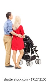 Young Parents Pushing A Baby Stroller Isolated On White Background, Rear View