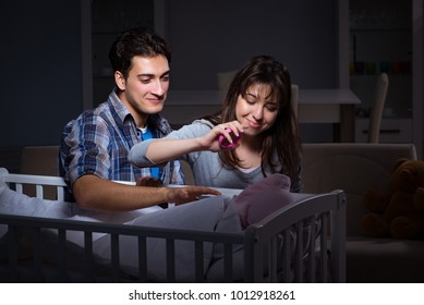 Young Parents Sleepless With Newborn Baby At Night