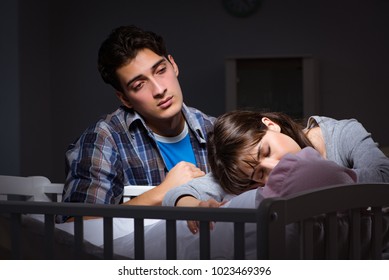 Young Parents Sleepless With Newborn Baby At Night