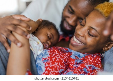 Young Parents With Their Baby Girl At Home
