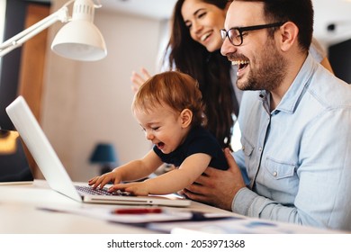 Young parents and their toddler son have a video call via laptop at home - Shutterstock ID 2053971368
