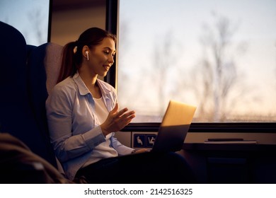 Young passenger having video call over her laptop while commuting by train. Copy space.
