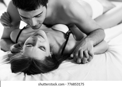Young passionate couple making love in bed.
