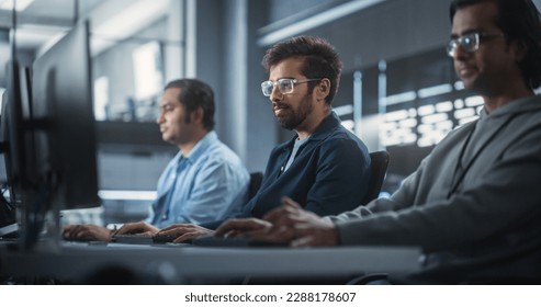 Young Passionate Specialist Working on Computer, Programming a Software for an Innovative Technological Internet Product Launch. Diverse Indian Team Working in a Startup Agency