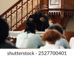 Young pastor passionately delivers a sermon to his congregation in a traditional church, emphasizing faith, love, and hope from the bible