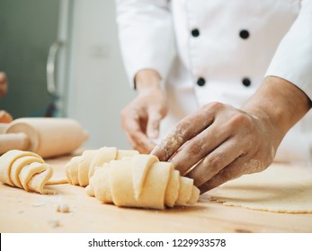 Young pastry chef making some croissant in the bakery. - Powered by Shutterstock