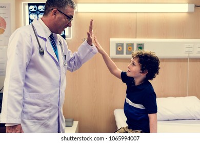 Young Patient Boy Giving A Doctor Hi Five