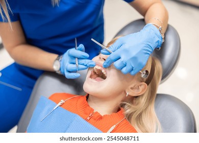 A young patient receives a dental checkup from a professional dentist, focusing on oral health care and examination in a well-equipped, modern dental office. - Powered by Shutterstock