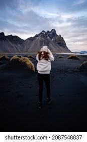 Young Peaceful Woman Enjoying View Of The Moss Covered Meadows In Iceland. Arctic Circle Wild Nature. People And Nature Connection. Traveling And Camping