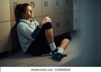 Young pensive athletic woman sitting in locker room and has no will for exercising.  - Powered by Shutterstock