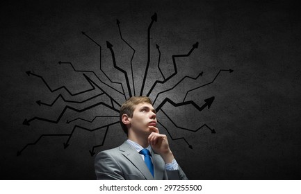 Young pensive businessman and thoughts coming out of his head - Shutterstock ID 297255500