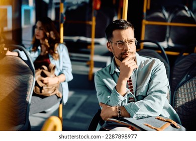 Young pensive man riding in a bus.  - Powered by Shutterstock