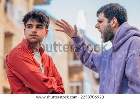 young people arguing in the street