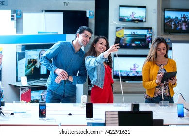 Young People Buying Latest Electronics. Shopping.