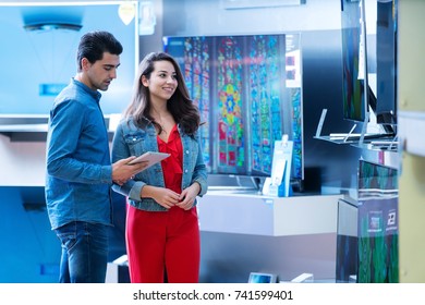 young people buying latest flat tv. shopping, concept - Shutterstock ID 741599401
