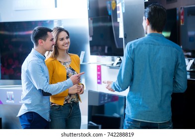 Young People Buying Latest Flat Tv. Shopping, Concept