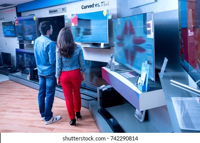 Young People Buying Latest Flat Tv. Shopping, Concept