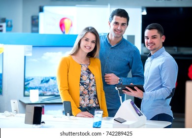 Young People Buying Latest Tablet At Tech Store