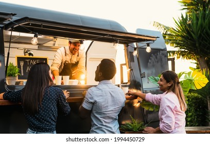 Young people buying meal from street food truck - Modern business and take away concept  - Powered by Shutterstock