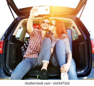 Young People In Car Trunk And Sunset Time 